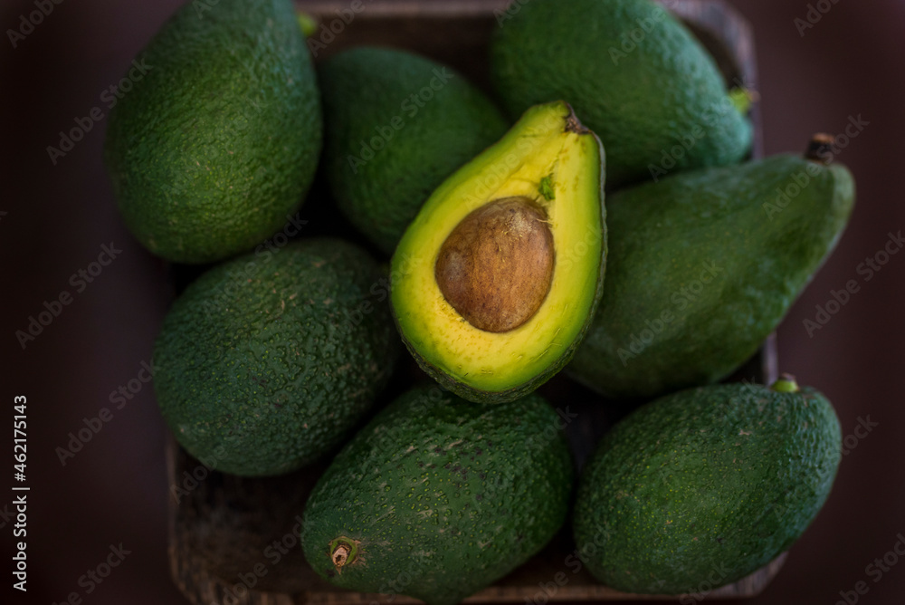 Avocados in basket on table Avocados in basket on table
