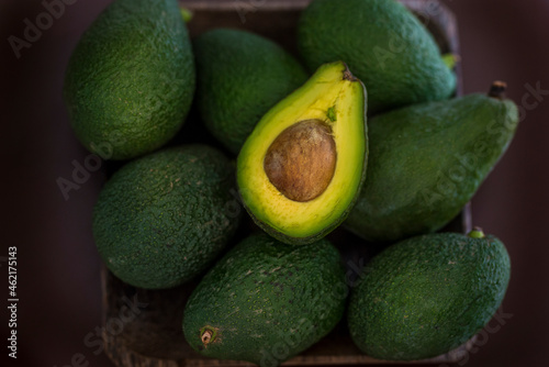 Avocados in basket on table photo