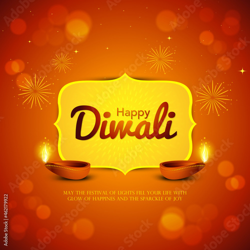 Happy Diwali background with illuminated oil lamps & Diwali greeting text isolated on defocused brown background.