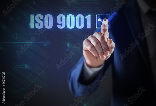 Man pointing at virtual screen with text ISO 9001, closeup