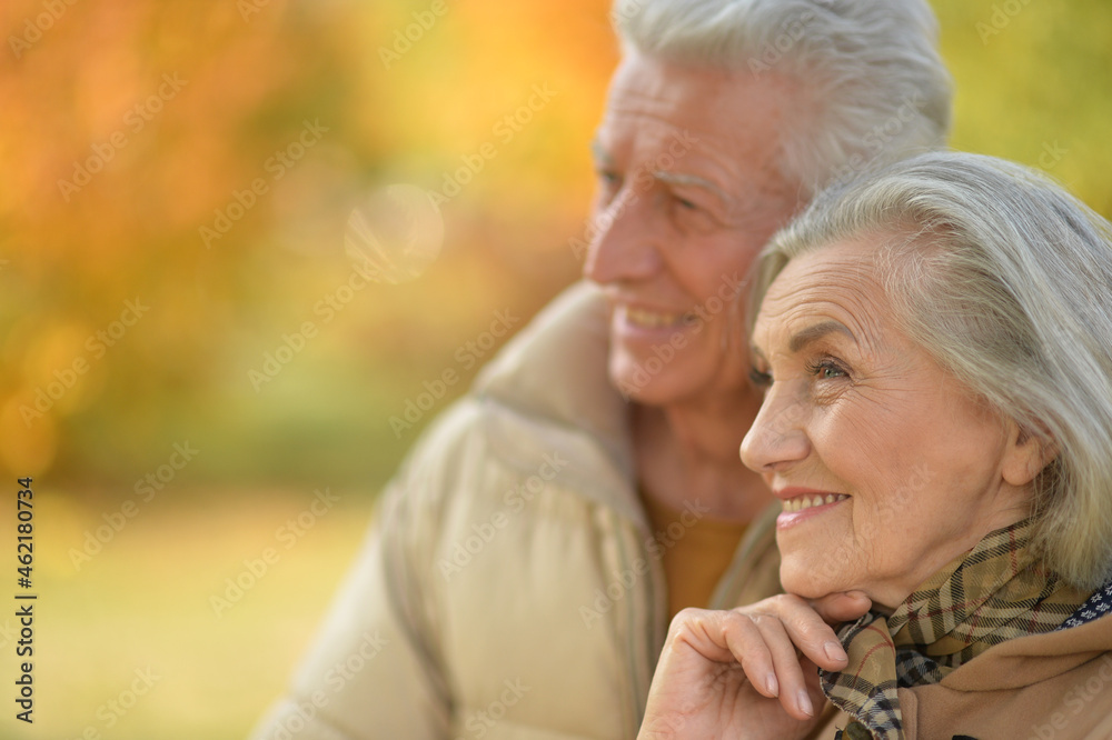 Happy senior couple in autumn park hugging Happy senior couple in autumn park hugging