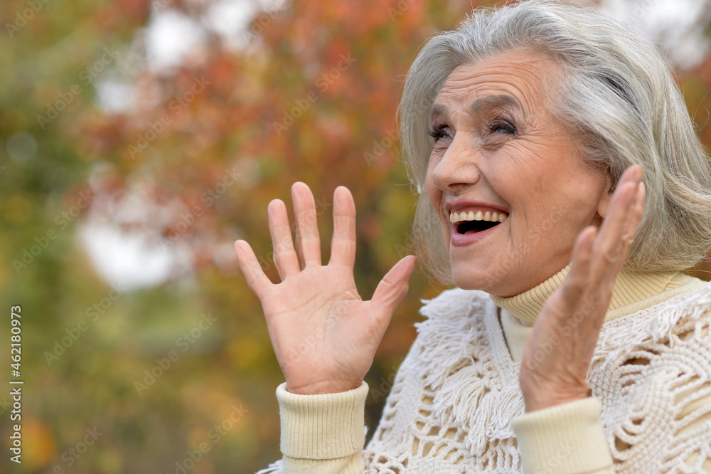 Portrait of happy senior beautiful woman in park