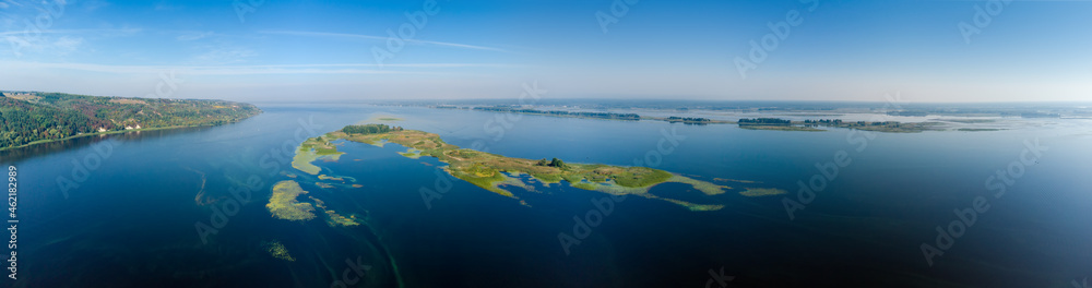 Wide river with forested banks and islands, aerial view Wide river with forested banks and islands, aerial view