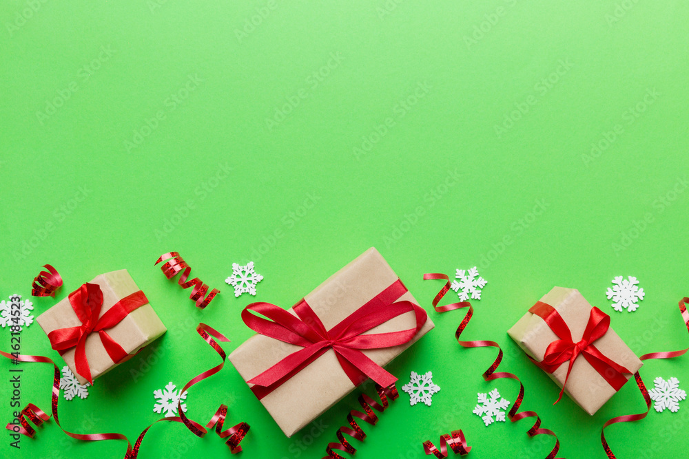 Holiday flat lay with gift boxes wrapped in colorful paper and tied decorated with confetti on colored background. Christmas, Birthday, Valentine and sale concept, top view Holiday flat lay with gift boxes wrapped in colorful paper and tied decorated with confetti on colored background. Christmas, Birthday, Valentine and sale concept, top view
