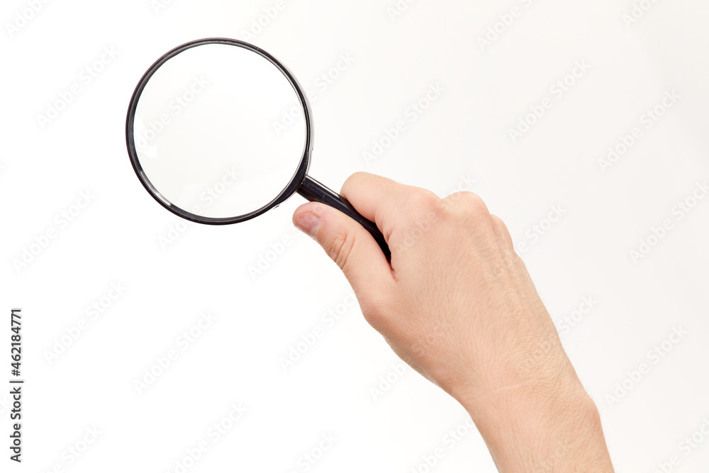 Magnifying glass in hand isolated on white background Magnifying glass in hand isolated on white background