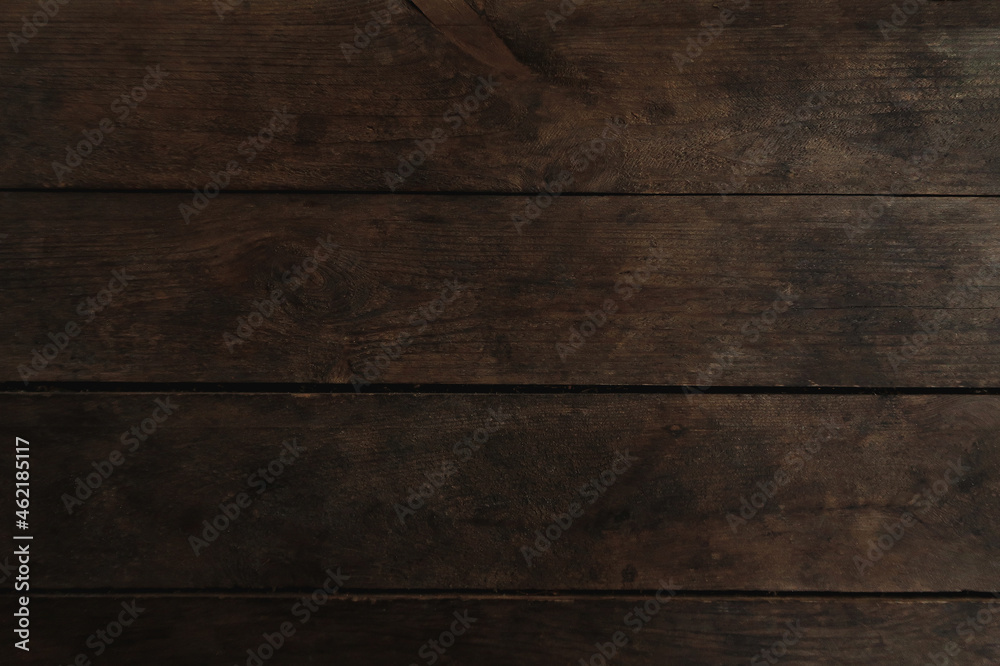 Naklejka premium Old dark brown wooden background. Timber board texture