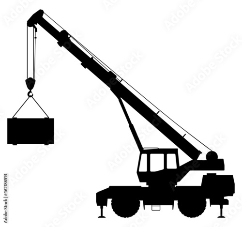 Silhouette of a crane lifting a load.