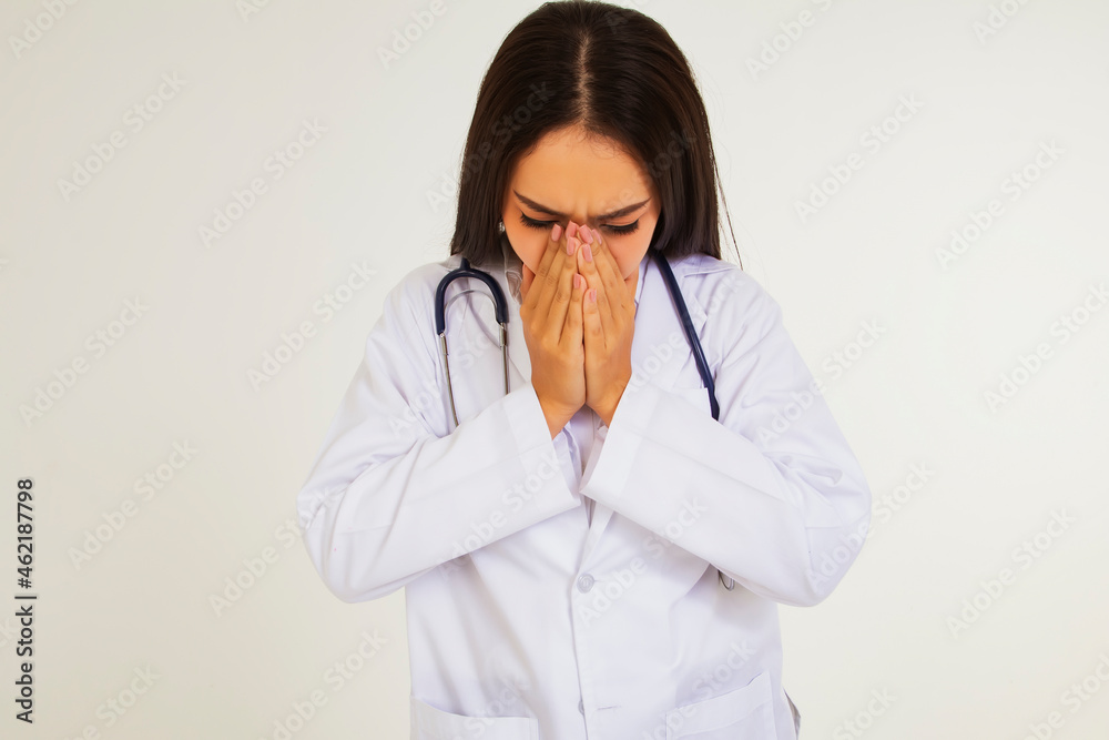 Female doctor sick with colds and allergies : Beautiful female doctor has symptoms of fatigue and discomfort due to a cold or bronchitis : health care concept Female doctor sick with colds and allergies : Beautiful female doctor has symptoms of fatigue and discomfort due to a cold or bronchitis : health care concept