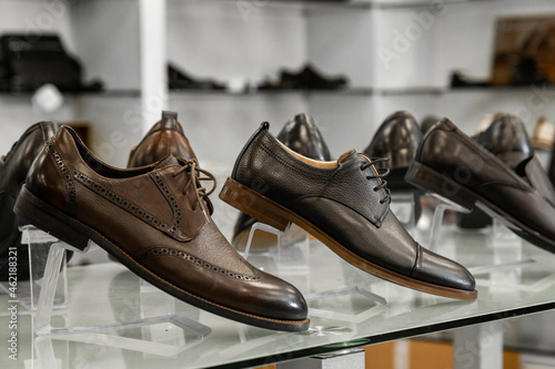 Men's brown and black summer shoes are at the forefront of the runways in the clothing store.