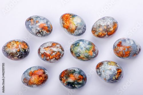 Colorful easter eggs painted in natural products blueberries and onion peels, isolated on white background,top view