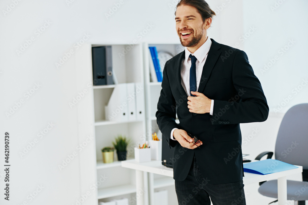 man in a suit in the office with documents technologies man in a suit in the office with documents technologies