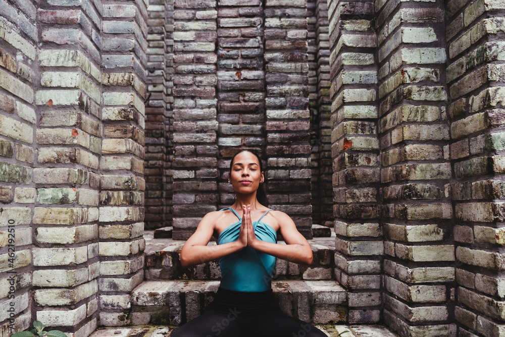 Female dancer with hands clasped doing relaxation exercise Female dancer with hands clasped doing relaxation exercise