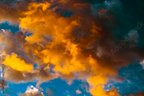 Dramatic orange clouds at sunset. Cloudscape abstract background photo. © senerdagasan