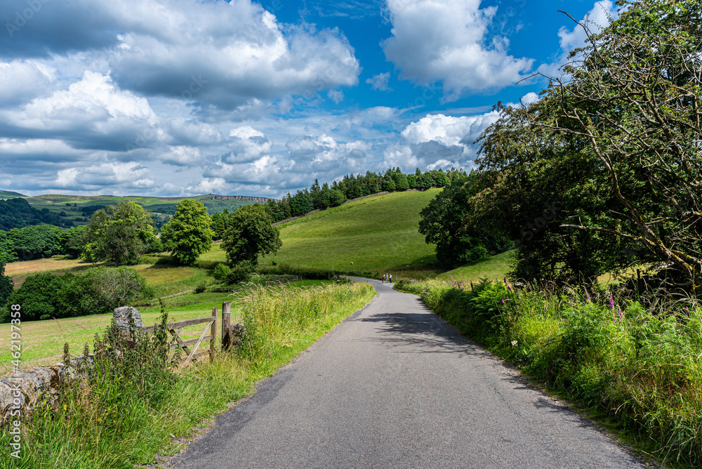 road in the countryside with blue skies and clouds