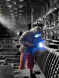 A welder at work in a shipyard.