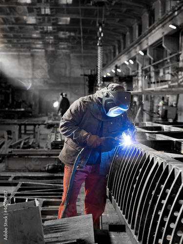 A welder at work in a shipyard.