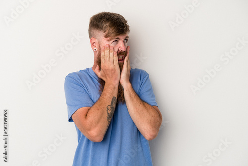 Young caucasian ginger man with long beard isolated on white background scared and afraid.