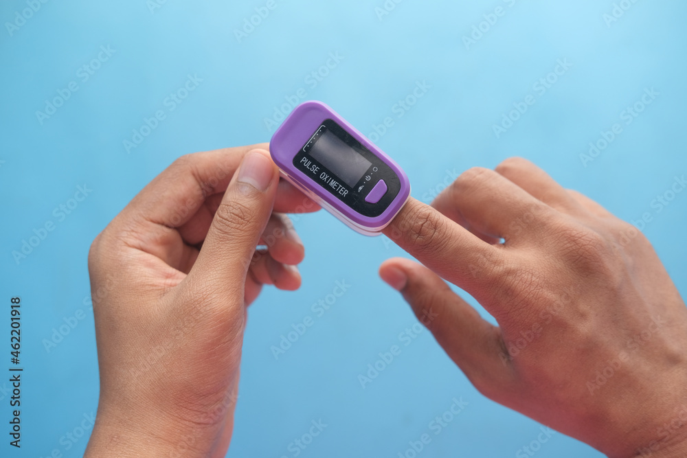 close up of man hand using pulse oximeter close up of man hand using pulse oximeter
