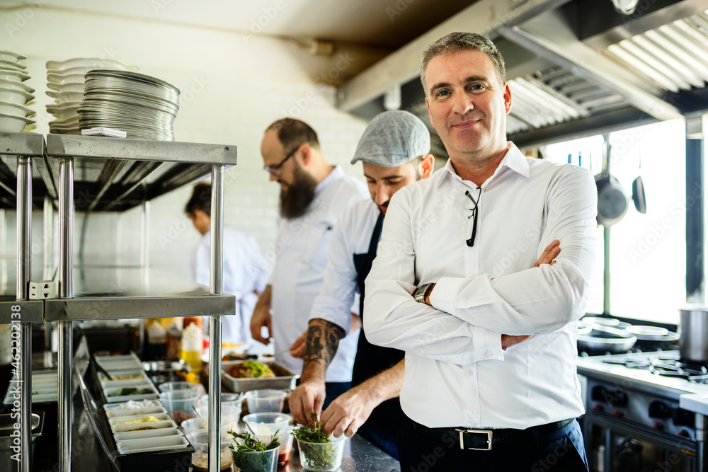 Restaurant kitchen chef with staff and manager Restaurant kitchen chef with staff and manager