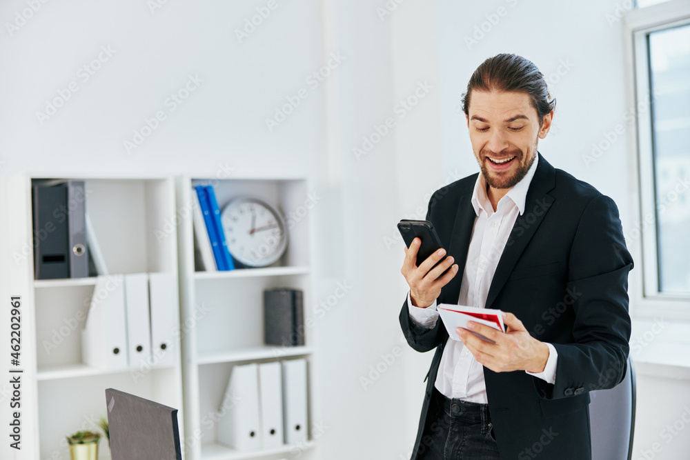 manager at the desk documents communication by phone technology manager at the desk documents communication by phone technology