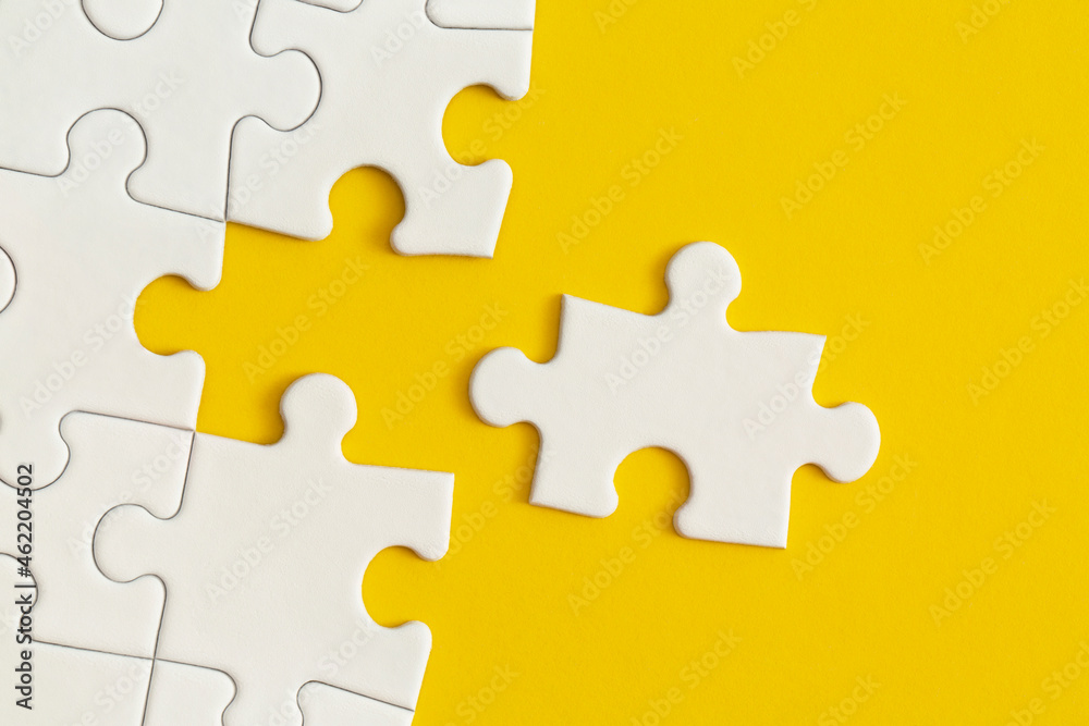 White details of puzzle on yellow background. Business strategy, teamwork. White details of puzzle on yellow background. Business strategy, teamwork.