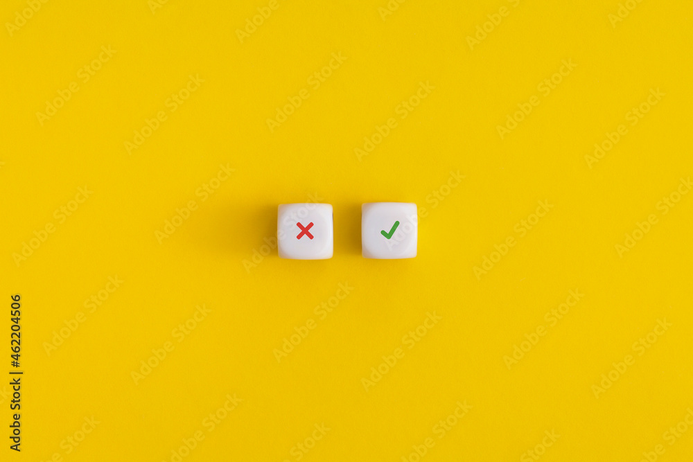 Cross and check mark on a white cubes on yellow background. Approving, voting or right decision concept. Cross and check mark on a white cubes on yellow background. Approving, voting or right decision concept.