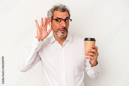 Middle age business man holding a take away coffee isolated on white background trying to listening a gossip.