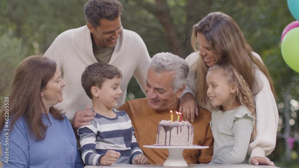 Medium Shot of Family Singing Happy Birthday to Grandfather Medium Shot of Family Singing Happy Birthday to Grandfather
