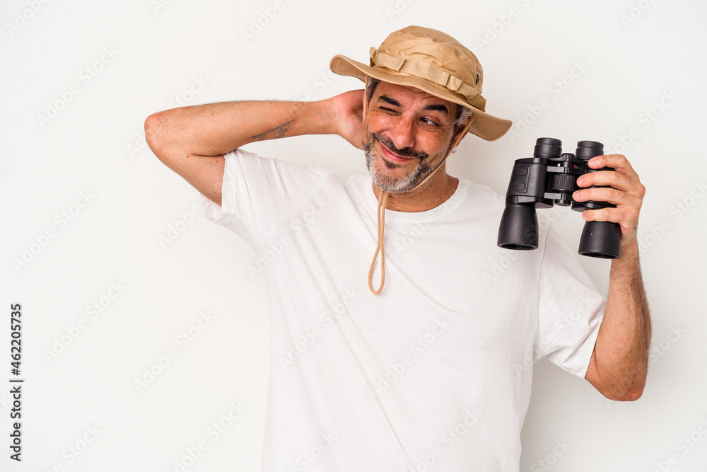 Middle age caucasian man holding binoculars isolated on white background touching back of head, thinking and making a choice. Middle age caucasian man holding binoculars isolated on white background touching back of head, thinking and making a choice.