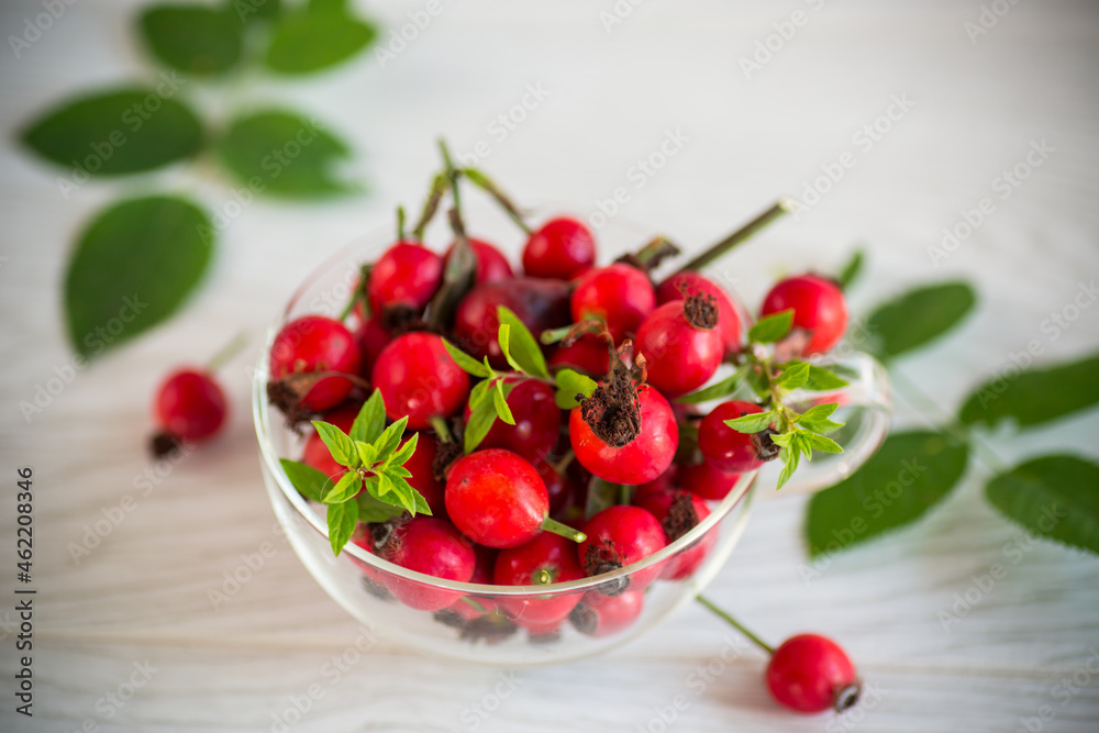 ripe red rose hips on a wooden table ripe red rose hips on a wooden table