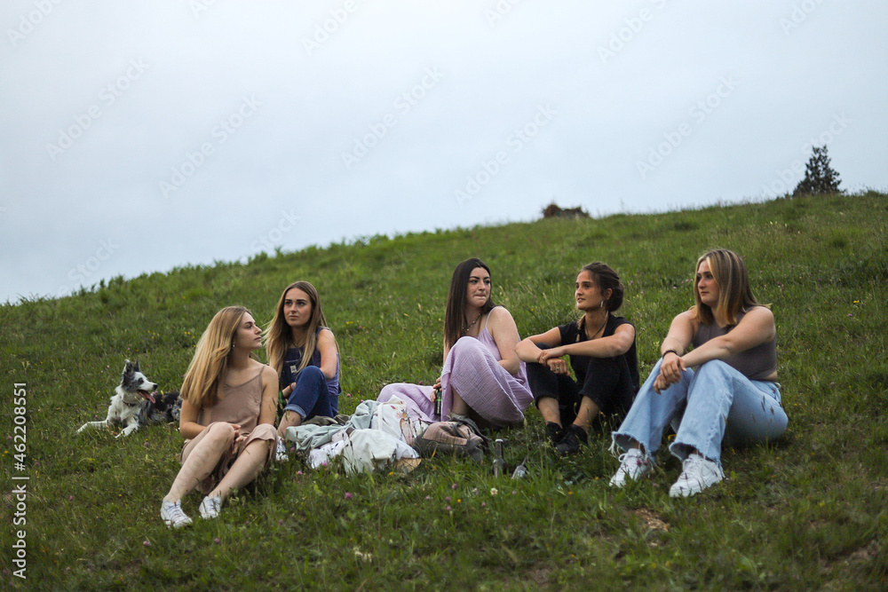 girlfriends smiling in nature in colorful dresses during spring girlfriends smiling in nature in colorful dresses during spring
