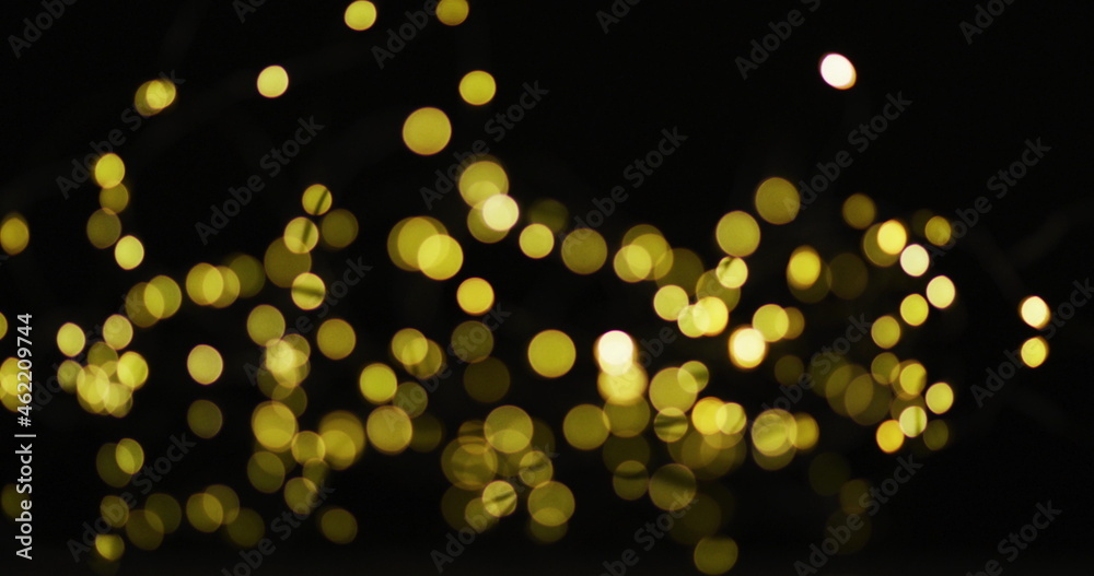 Multiple yellow fairy lights glowing on black background Multiple yellow fairy lights glowing on black background