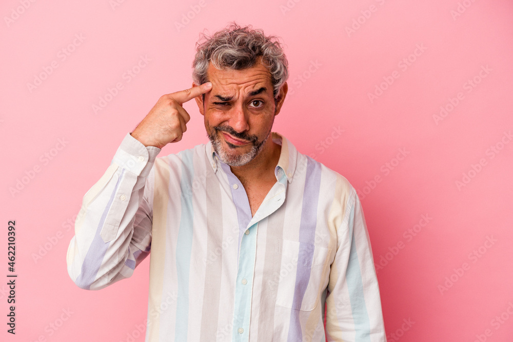 Middle age caucasian man isolated on pink background pointing temple with finger, thinking, focused on a task. Middle age caucasian man isolated on pink background pointing temple with finger, thinking, focused on a task.