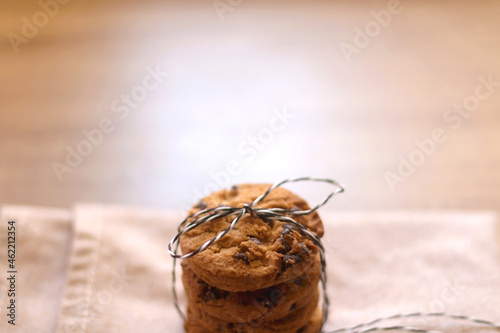 Stack of chocolate chip cookies, tied with ribbon. Selective focus.