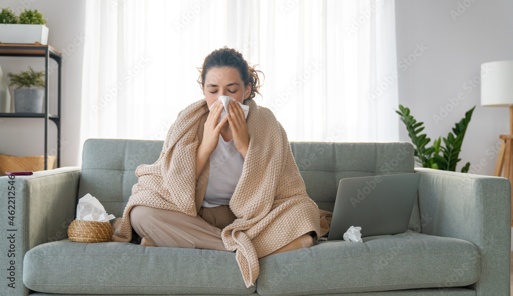 Fototapeta premium girl is holding paper tissue and blowing nose