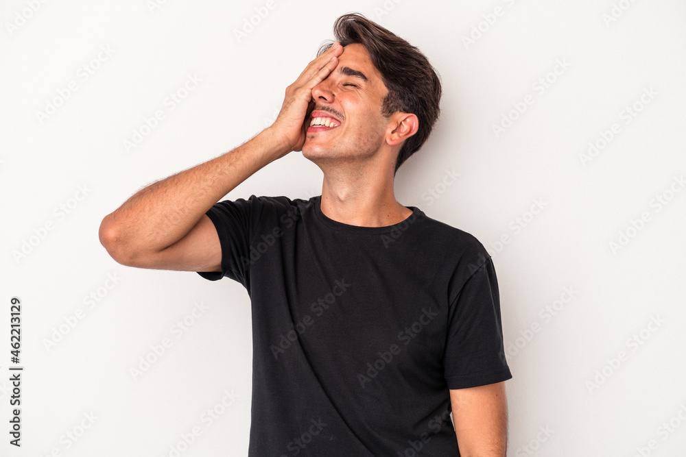 Young mixed race man isolated on white background laughing happy, carefree, natural emotion. Young mixed race man isolated on white background laughing happy, carefree, natural emotion.