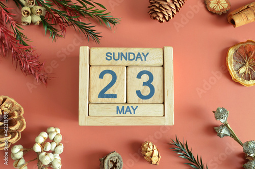 May 23, Cover design with calendar cube, pine cones and dried fruit in the natural concept.