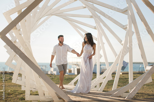 Man and woman posing. Geometric wooden structures. The bride and groom. © Artem Zakharov