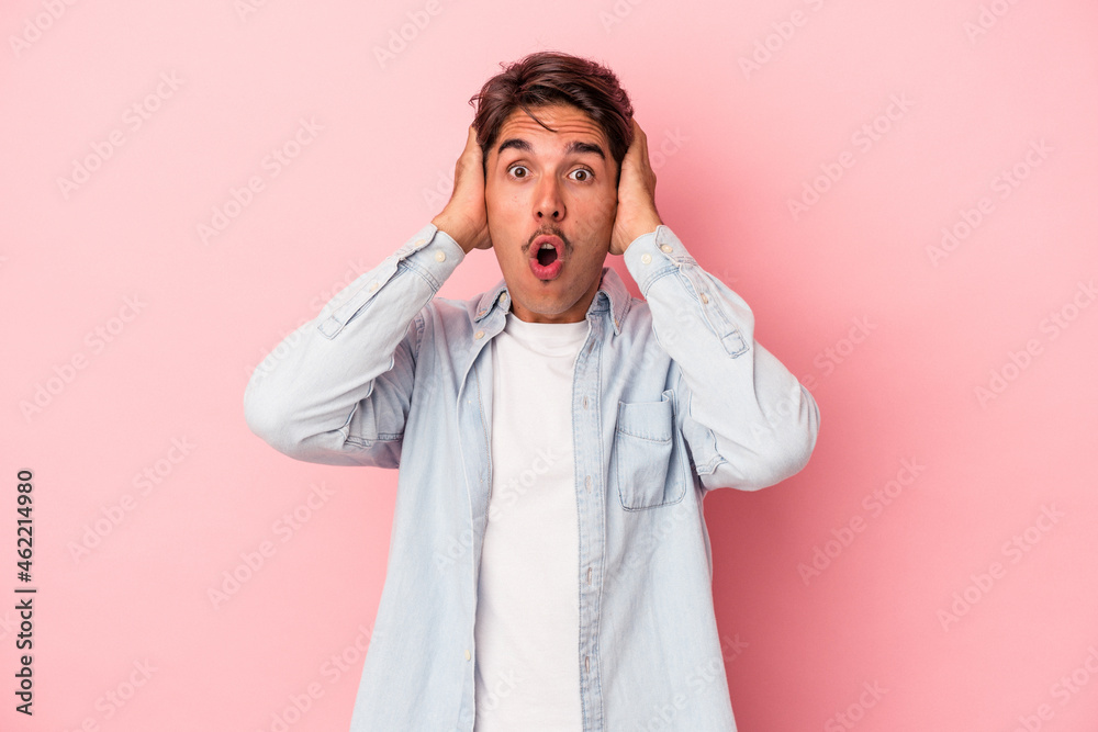 Young mixed race man isolated on white background being shocked, she has remembered important meeting. Young mixed race man isolated on white background being shocked, she has remembered important meeting.