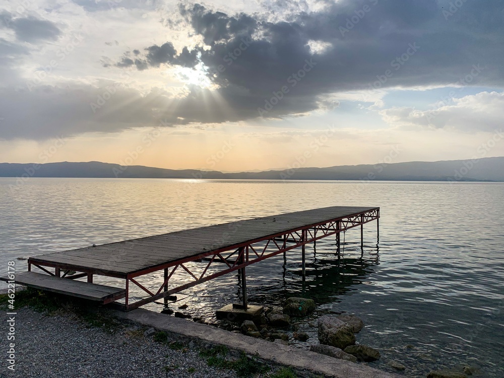 Obraz premium Small wooden pier at the sea, sunset time, no people
