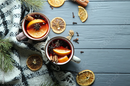 Hot winter cocktail, mulled wine on a wooden background. Top view, space for text.