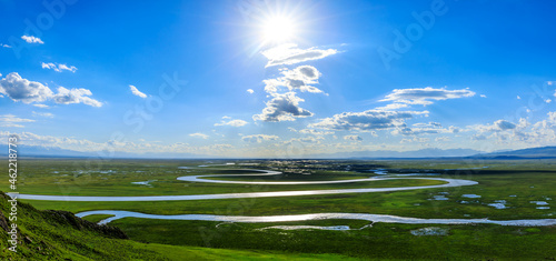 Bayinbuluke Grassland and winding river natural scenery in Xinjiang,China.The winding river is on the green grassland. photo
