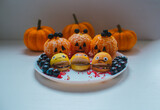 Halloween food background containing pumpkins, apples, tangerines, blueberries