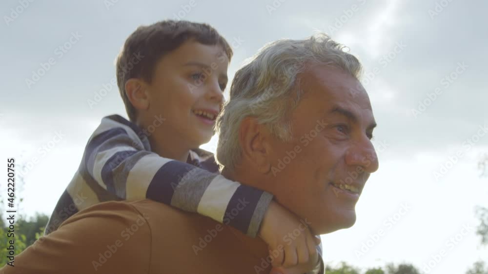 Portrait Shot of Young Boy Getting Piggy Back from His Grandfather 01 Portrait Shot of Young Boy Getting Piggy Back from His Grandfather 01
