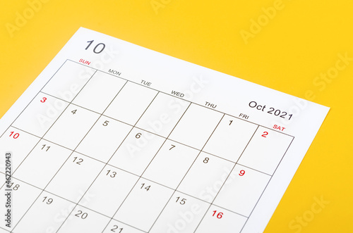 October 2012 calendar sheet on yellow background. © gamjai