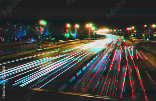 Night traffic in Krasnoyarsk city with glitch effect. Bright background with imitation of technical distortion.