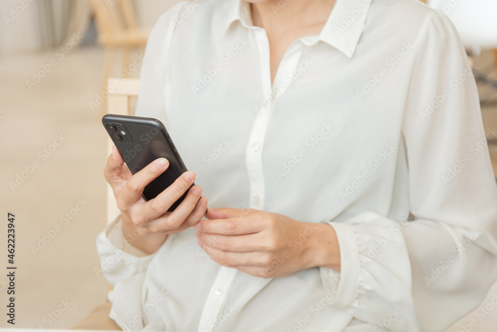 using cell phone hand holding mobile texting message contact us.chatting,search internet information in office.technology device communication connecting using cell phone hand holding mobile texting message contact us.chatting,search internet information in office.technology device communication connecting
