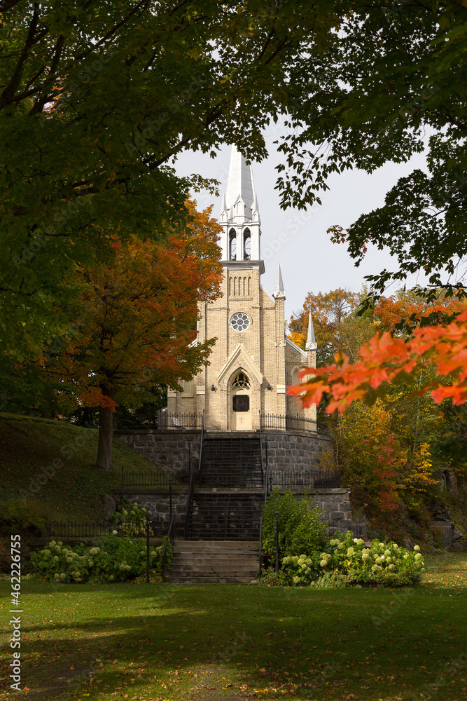 Fototapeta premium Pretty small 1879 gothic revival Notre-Dame-de-Lourdes Chapel seen in the Fall on hill dominating the St-Michel-de-Bellechasse village, Quebec, Canada