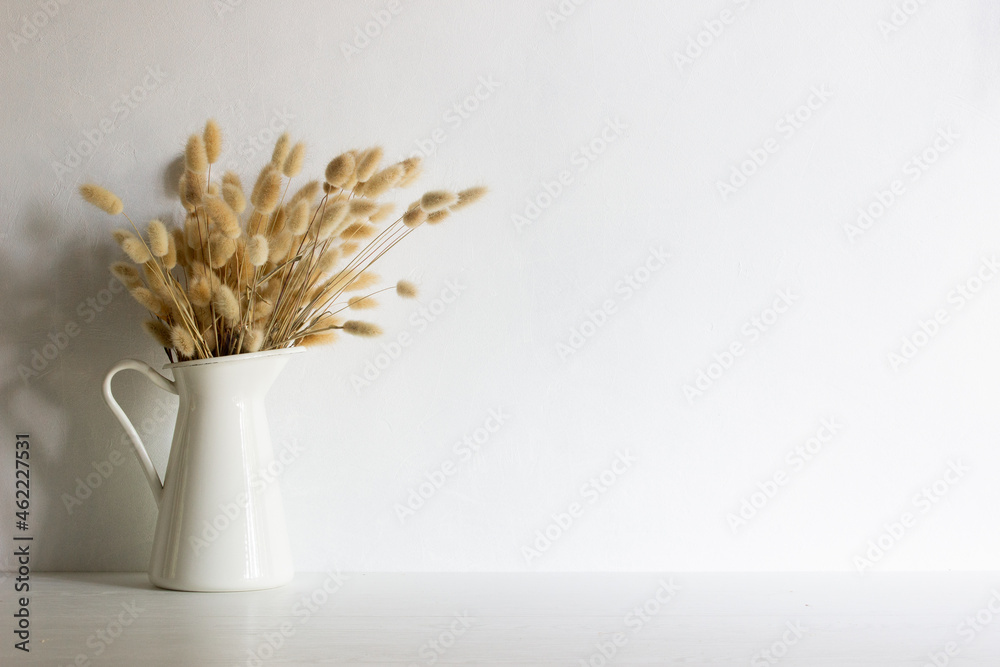 Organic brown flowers in a vase with nature light.  - obrazy, fototapety, plakaty 
