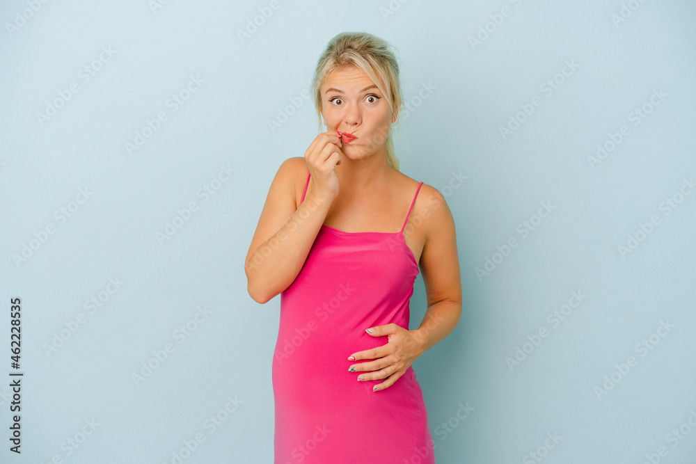 Young Russian woman pregnant isolated on blue background with fingers on lips keeping a secret. Young Russian woman pregnant isolated on blue background with fingers on lips keeping a secret.